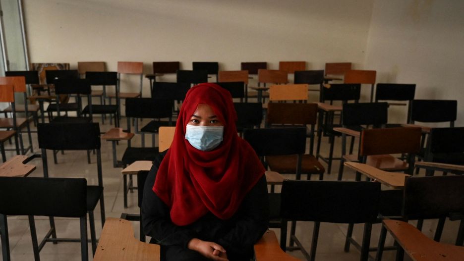 TemporaryA student sits inside a classroom after private universities reopened in Kabul on September 6, 2021. - Women attending private Afghan universities must wear an abaya robe and niqab covering most of the face, the Taliban have ordered, and classes must be segregated by sex -- or at least divided by a curtain. (Photo by Aamir QURESHI / AFP)AAMIR QURESHI