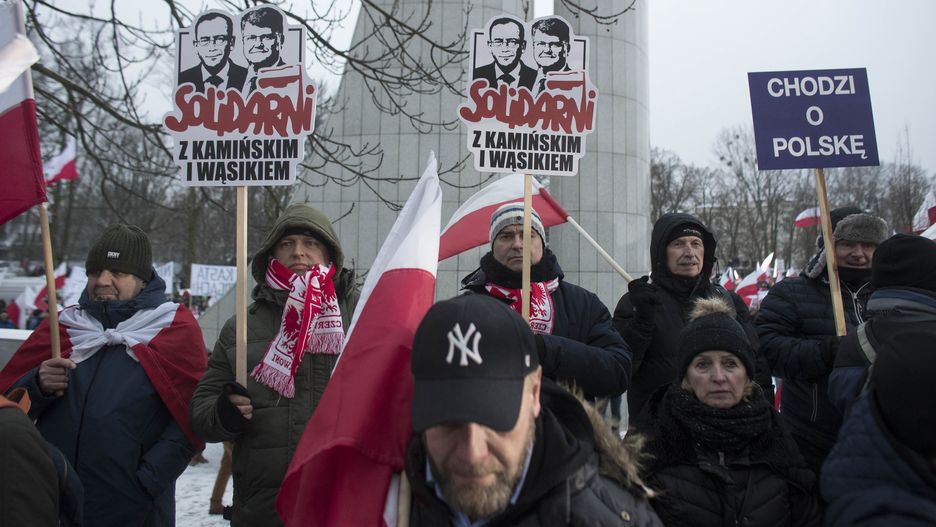 People are holding a ''Solidarity with Kaminski and Wasik'' placard at the March of Free Poles, which is being organized by the opposition Law and Justice (Prawo i Sprawiedliwosc) party. They are protesting against changes in public media and the arrest of PiS politicians Mariusz Kaminski and Maciej Wasik in Warsaw, Poland, on January 11, 2024. (Photo by Maciej Luczniewski/NurPhoto via Getty Images)