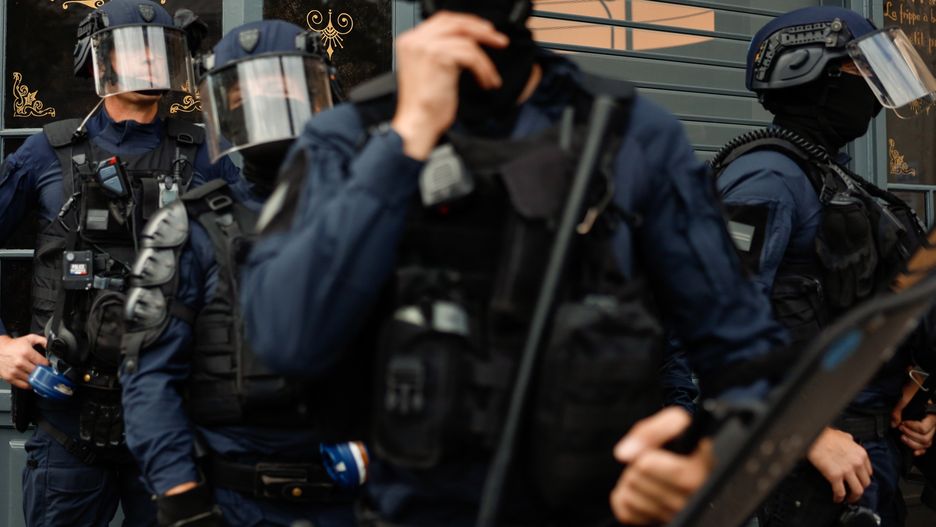 PARIS, FRANCE - SEPTEMBER 23: Police stand beside a bar reading "nice" during the march to denounce police violence on September 23, 2023 in Paris, France. Nearly one hundred parties, unions and associations organised a "unitary march" against "police violence" and "systemic racism" on Saturday September 23 in the French capital.