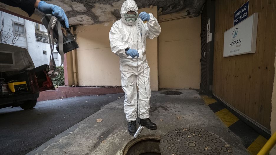 MARSEILLE, FRANCE - DECEMBER 21: A firefighter from the Marins-Pompiers of Marseille, wearing a protective suit, takes samples from Marseille sewage water near a retirement home (Ehpad) to detect COVID-19 traces on December 21, 2020 in Marseille, France. The concentration of the Coronavirus pathogen released in human waste acts as an early warning system for France in the face of the pandemic. (Photo by Arnold Jerocki/Getty Images)
