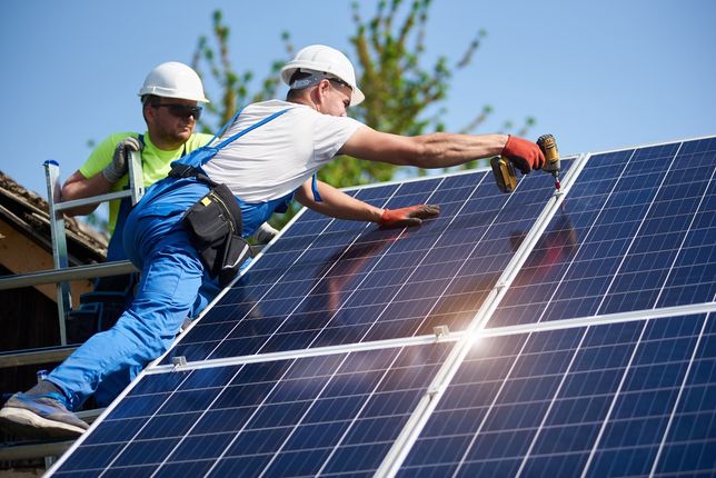 Stand-alone exterior solar panel system installation, renewable green energy generation concept.Two workers technicians installing heavy solar photo voltaic panels to high steel platform. Exterior solar system installation, alternative renewable green energy generation concept.system, solar, power, energy, panels, technology, installation, exterior, renewable, alternative, generator, photovoltaic, install, mounting, maintenance, supply, environmental, eco, green, electrical, generation, building, ecological, electric, construction, worker, technician, installer, engineer, professional, men, team, electricity, light, economy, modern, resource, module, background, blue, screwdriver, hight, recycling, structure, cells, texture, price, investment, assemble, eco friendly, system, solar, power, energy, panels, technology, installation, exterior, renewable, alternative, generator, photovoltaic, install, mounting, maintenance, supply, environmental, eco, green, electrical, generation, building, ecological, electric, construction, worker, technician, installer, engineer, professional, men, team, electricity, light, economy, modern, resource, module, background, blue, screwdriver, hight, recycling, structure, cells, texture, price, investment, assemble, eco friendly