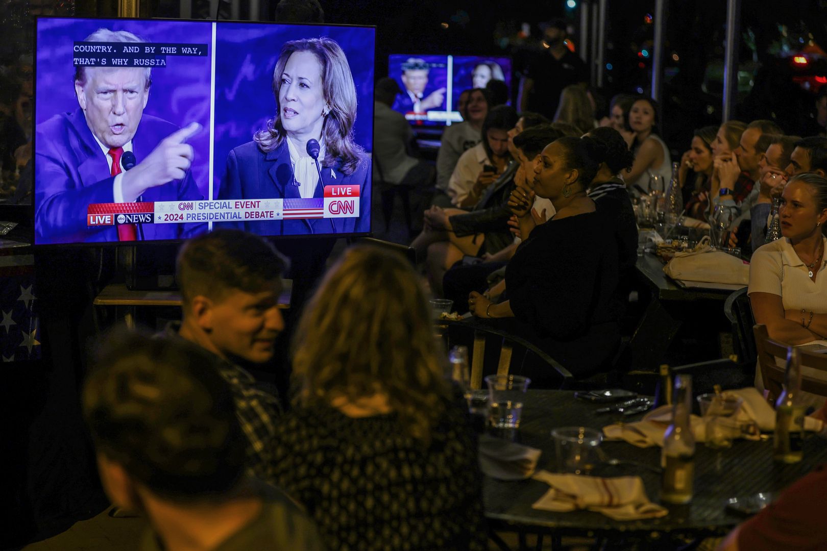 WASHINGTON, DC - SEPTEMBER 10: People watch the presidential debate during a debate watch party at Shaw’s Tavern on September 10, 2024 in Washington, DC. Democratic presidential nominee, U.S. Vice President Kamala Harris and Republican presidential nominee, former President Donald Trump face off in their first debate Tuesday evening at The National Constitution Center in Philadelphia, Pennsylvania. (Photo by Alex Wong/Getty Images)