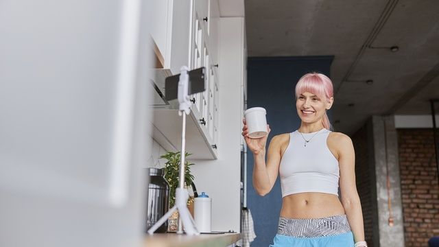 Positive woman holds jar of protein supplement shooting video at home
Positive woman fitness trainer holds jar of protein supplement shooting new video with mobile phone in light kitchen
yaroslav astakhov
young, positive, lady, woman, pink, fitness, blogger, hair, home, new, mobile, care, video, phone, healthy, nutrition, lifestyle, technology, contemporary, kitchen, close up, female, Caucasian, athletic, meal, sport, vlog, camera, food, blog, diet, streaming, vlogger, business, smartphone, athlete, diary, recording, sportswoman, trainer, shows, jar, shooting, dietary, holds, supplement, protein