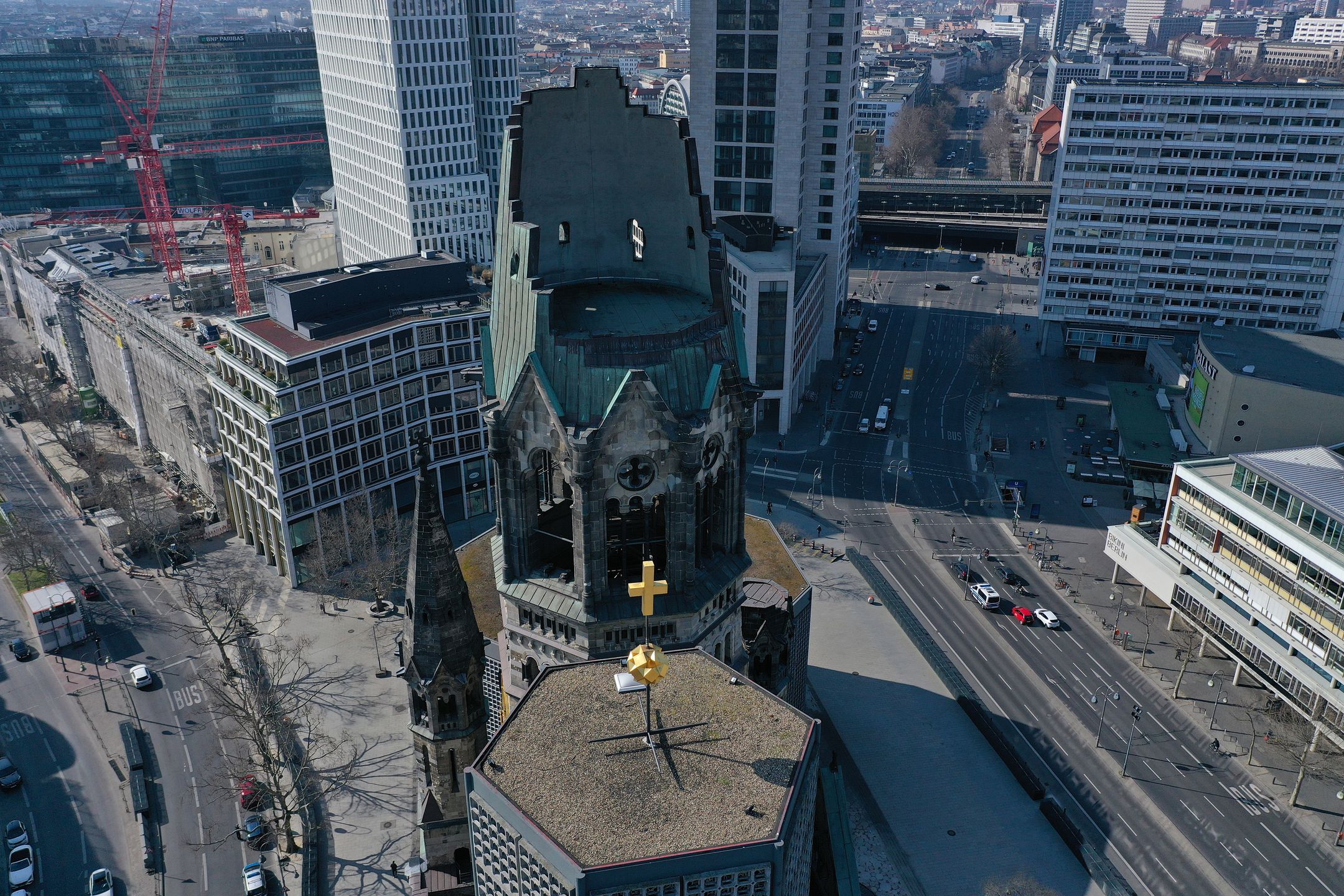 BERLIN, GERMANY - MARCH 27: (EDITOR'S NOTE: Photo taken with a drone.) In this aerial view the Kaiser Wilhelm Memorial Church stands over nearly empty Breitscheidplatz square during the coronavirus crisis on March 27, 2020 in Berlin, Germany. The coronavirus and the disease it causes, COVID-19, are having a fundamental impact on society, government and the economy in Germany. Public life has been restricted to the essentials in an effort by authorities to slow the spread of infections. Hospitals are scrambling to increase their testing and care capacity. An economic recession seems likely as economic activity is slowed and many businesses are temporarily closed. Schools, daycare centers and universities remain shuttered. And government, both federal and state, seek to mobilize resources and find adequate policies to confront the virus and mitigate its impact. (Photo by Sean Gallup/Getty Images)