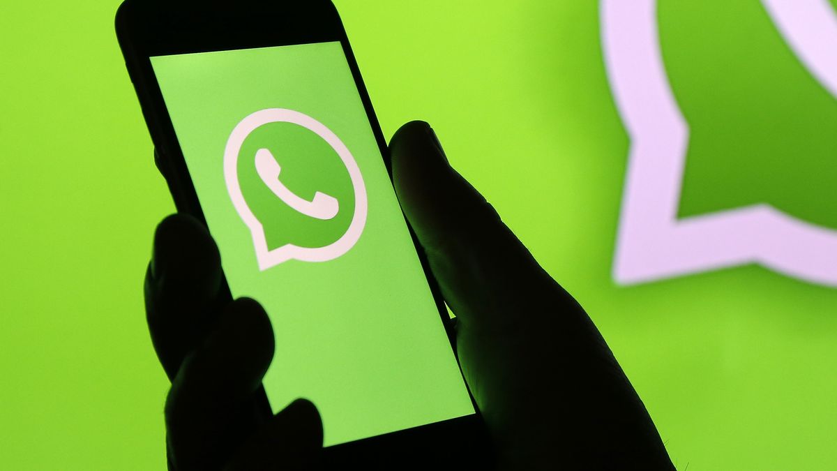 PARIS, FRANCE - DECEMBER 10: In this photo illustration, the WhatsApp logo is displayed on the screen of an iPhone in front of a TV screen displaying the WhatsApp logo on December 10, 2019 in Paris, France. The WhatsApp instant messenger service will stop working on millions of phones in the next couple of months as the company withdraws support for some older mobile platforms. From February 1, 2020, any iPhone running iOS 8 or older will no longer be supported, along with any Android device running version 2.3.7 or older. (Photo by Chesnot/Getty Images)