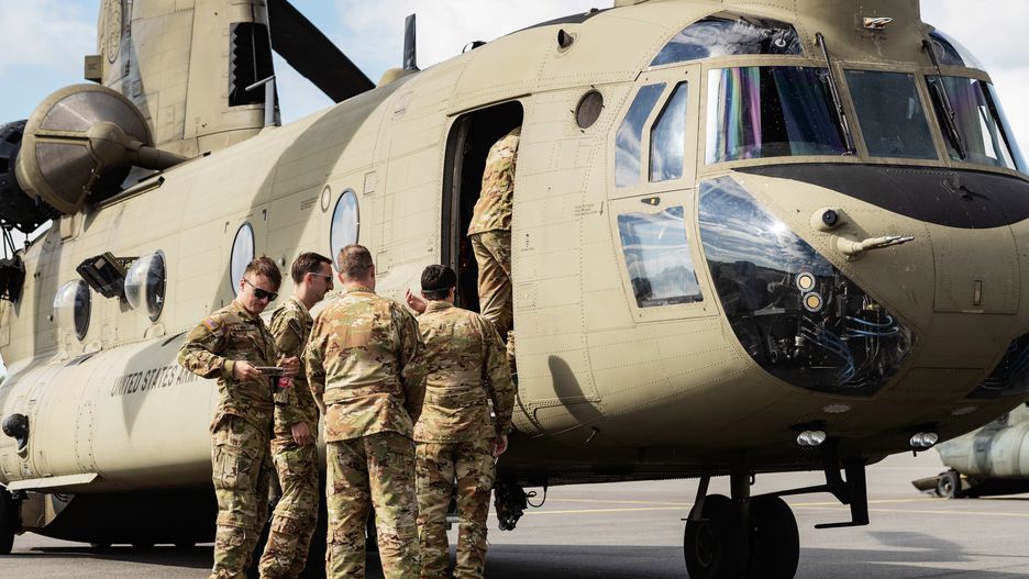 Soldiers approach a CH-47 Chinook from the US army aviation, 12th Combat Aviation Brigade, during a joint military helicopter training exercise hosted by the Finnish Army's Utti Jaeger Regiment in Pirkkala, Finland, on Wednesday, Aug. 3, 2022. NATO leaders prepared to overhaul and boost the alliances defences in the face of Russian aggression in Europe, including establishing a new force model that would put about 300,000 troops on high alert to deal with any future threats. Photographer: Roni Rekomaa/Bloomberg via Getty Images
