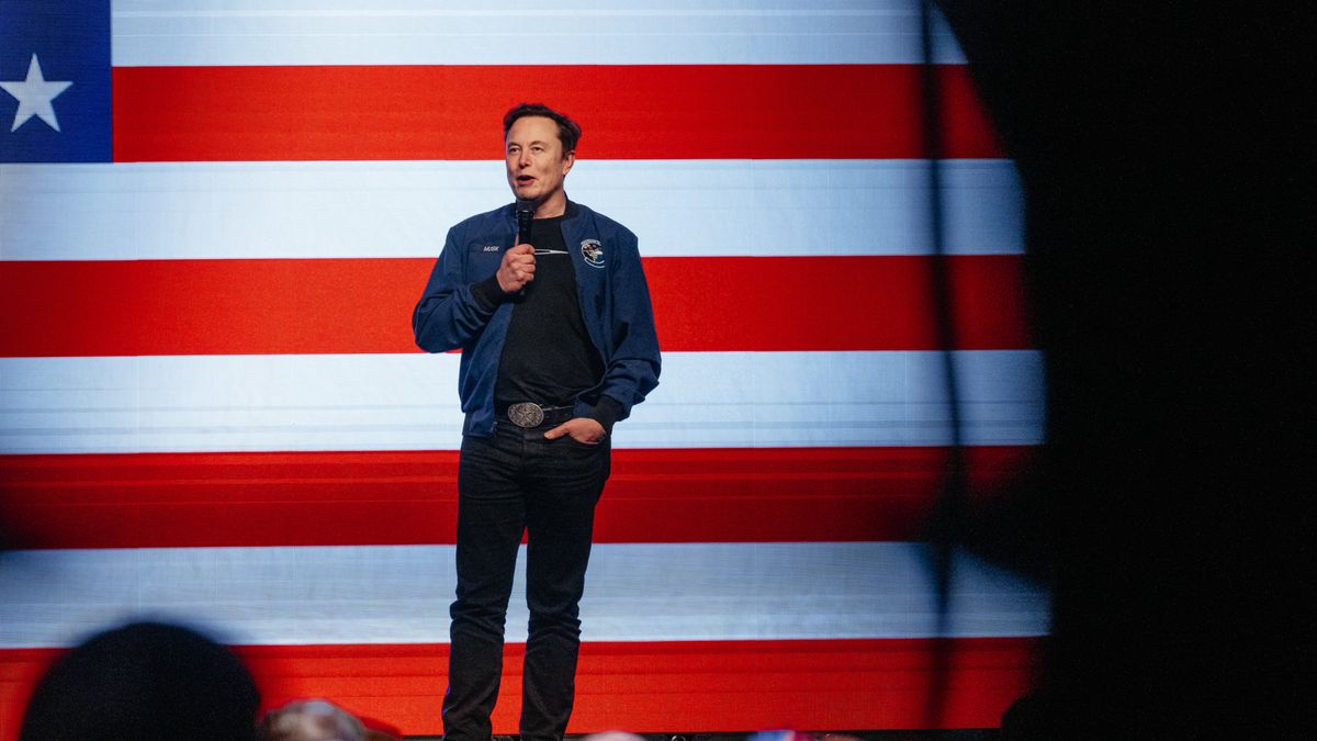 Elon Musk, chief executive officer of Tesla Inc., speaks during an America PAC town hall ahead of the Wisconsin Supreme Court election at the KI Convention Center in Green Bay, Wisconsin, US, on Sunday, March 30, 2025. Musk's plan to hand out $1 million checks to two residents for participating in Wisconsin's Supreme Court election is barred by state law, a new complaint said Friday. Photographer: Jamie Kelter Davis/Bloomberg via Getty Images