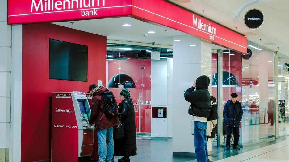 Customers use Millenium Bank Zao automated teller machines (ATM) inside the Galeria Wilenska shopping mall in Warsaw, Poland, on Thursday, Dec. 21, 2023. The central bank halted interest rate cuts after the Oct. 15 parliamentary election unexpectedly brought the pro-European Union opposition to power, along with their promises to boost budget spending. Photographer: Damian Lemaski/Bloomberg via Getty Images