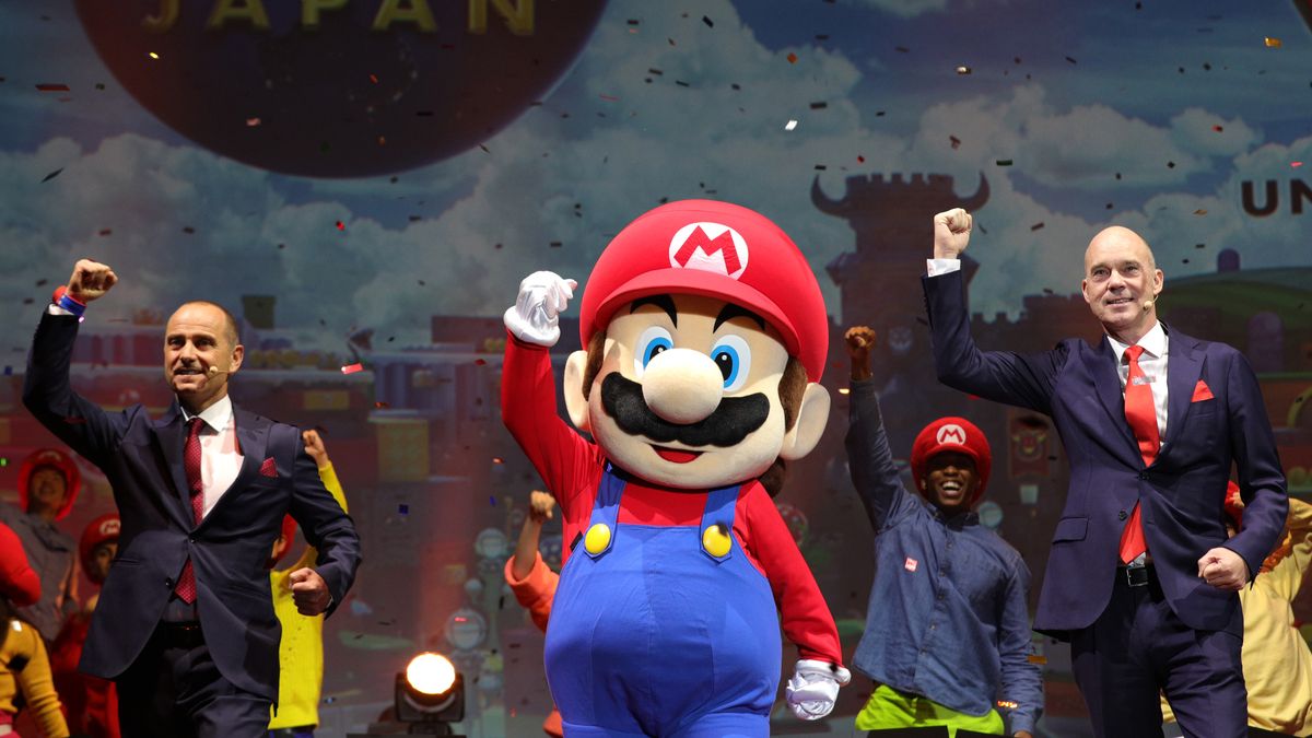 Thierry Coup, senior vice president of Universal Creative, left, and J. L. Bonnier, chief executive officer of USJ LLC, perform on stage with an actor dressed as Nintendo Co. video-game Super Mario Brothers character Mario during a news briefing at Universal Studios Japan in Osaka, Japan, on Tuesday, Jan. 14, 2020. Nintendo Co. fans can soon experience a life-sized video game via a new attraction at Universal Studios Japan. Super Nintendo World is slated to open this summer in Osaka, featuring a Power Up Band wearable that lets visitors collect coins and battle bosses while exploring a physical environment. Photographer: Buddhika Weerasinghe/Bloomberg via Getty Images