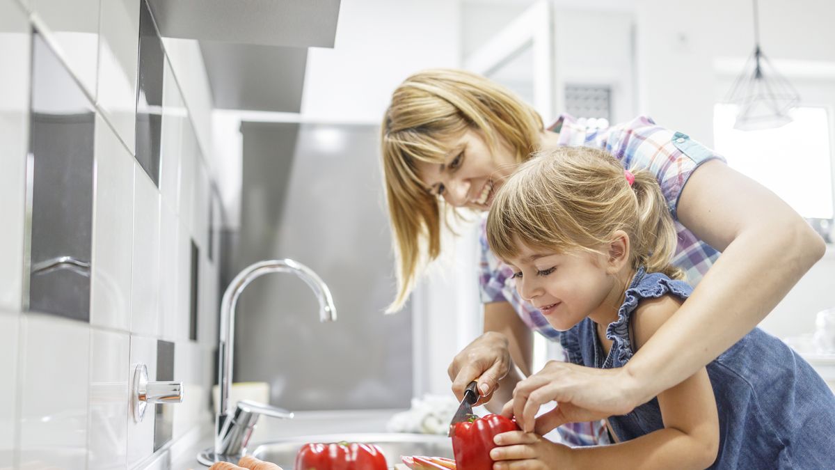 Happy female part of the family making dinner