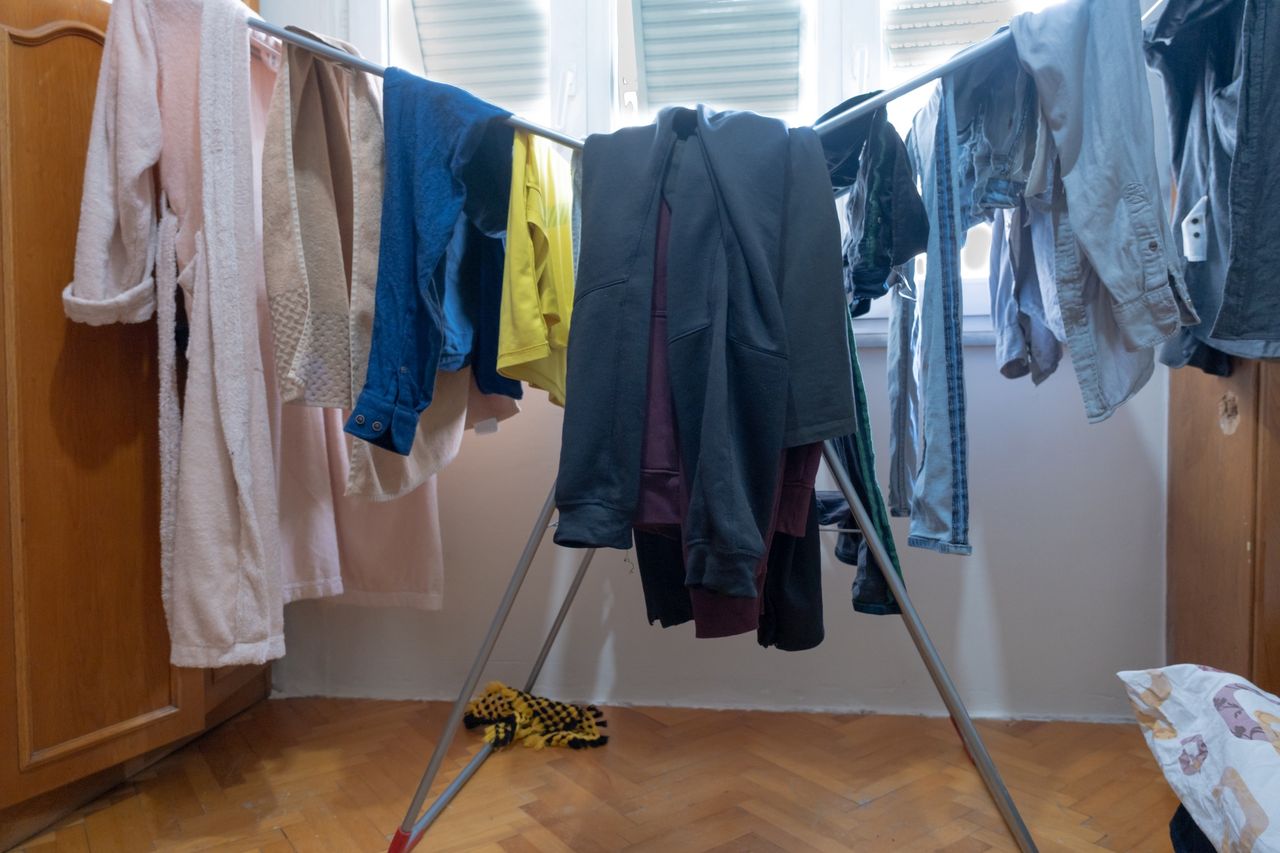 hanging clothes on laundry clothesline in living room
some newly washed drying clothes in the house
loopulacrum