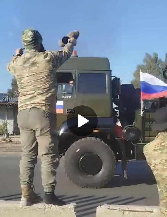 Syrians wave shoes towards departing Russians