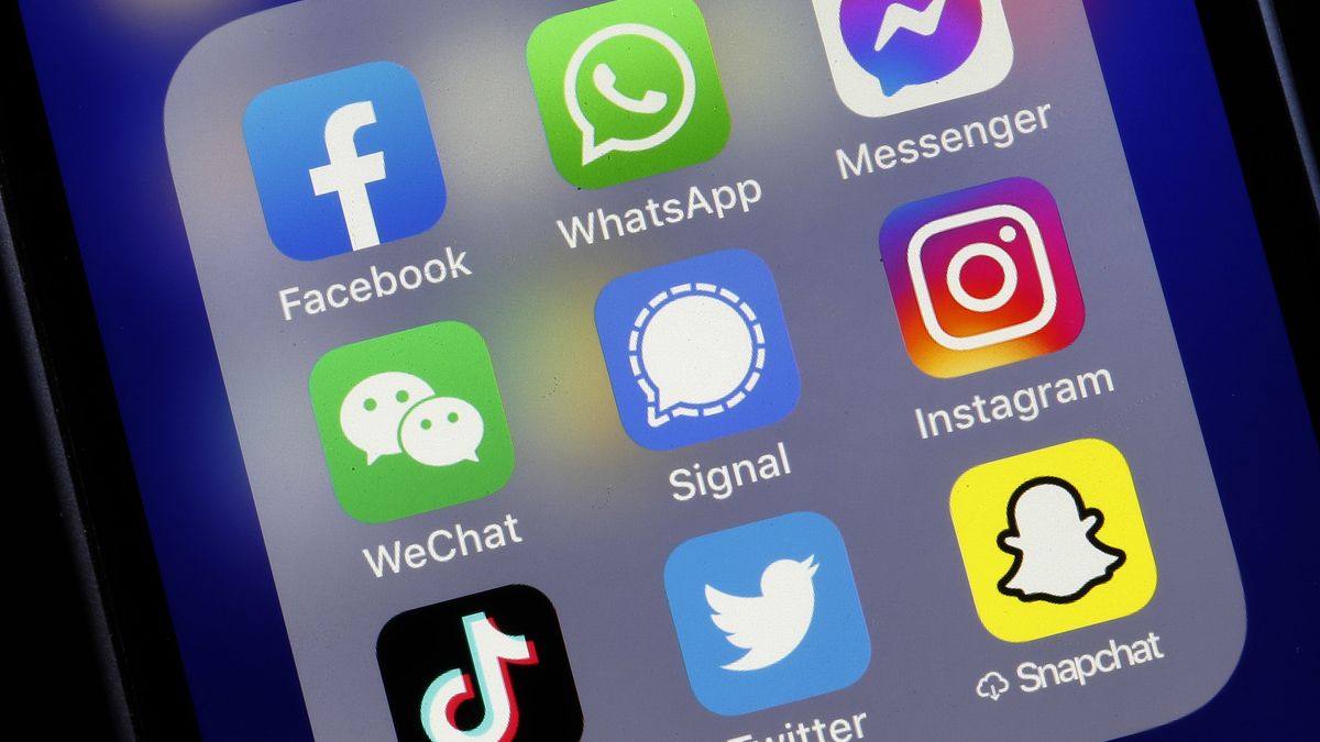 PARIS, FRANCE - JANUARY 11: In this photo illustration, the logos of social media applications, Facebook, WhatsApp, Messenger, WeChat, Signal, Instagram, TikTok, Twitter and Snapchat are displayed on the screen of an iPhone on January 11, 2021 in Paris, France. In recent days, many WhatsApp users have migrated to Signal following the modification of WhatsApp's terms of use concerning personal data. WhatsApp has come under fire since Thursday after asking its nearly two billion users to agree to new terms of service, allowing it to share more data with its parent company Facebook. As a result, the Signal messaging application is experiencing a very strong increase in its subscriptions to the point of undergoing saturation phases. (Photo illustration by Chesnot/Getty Images)