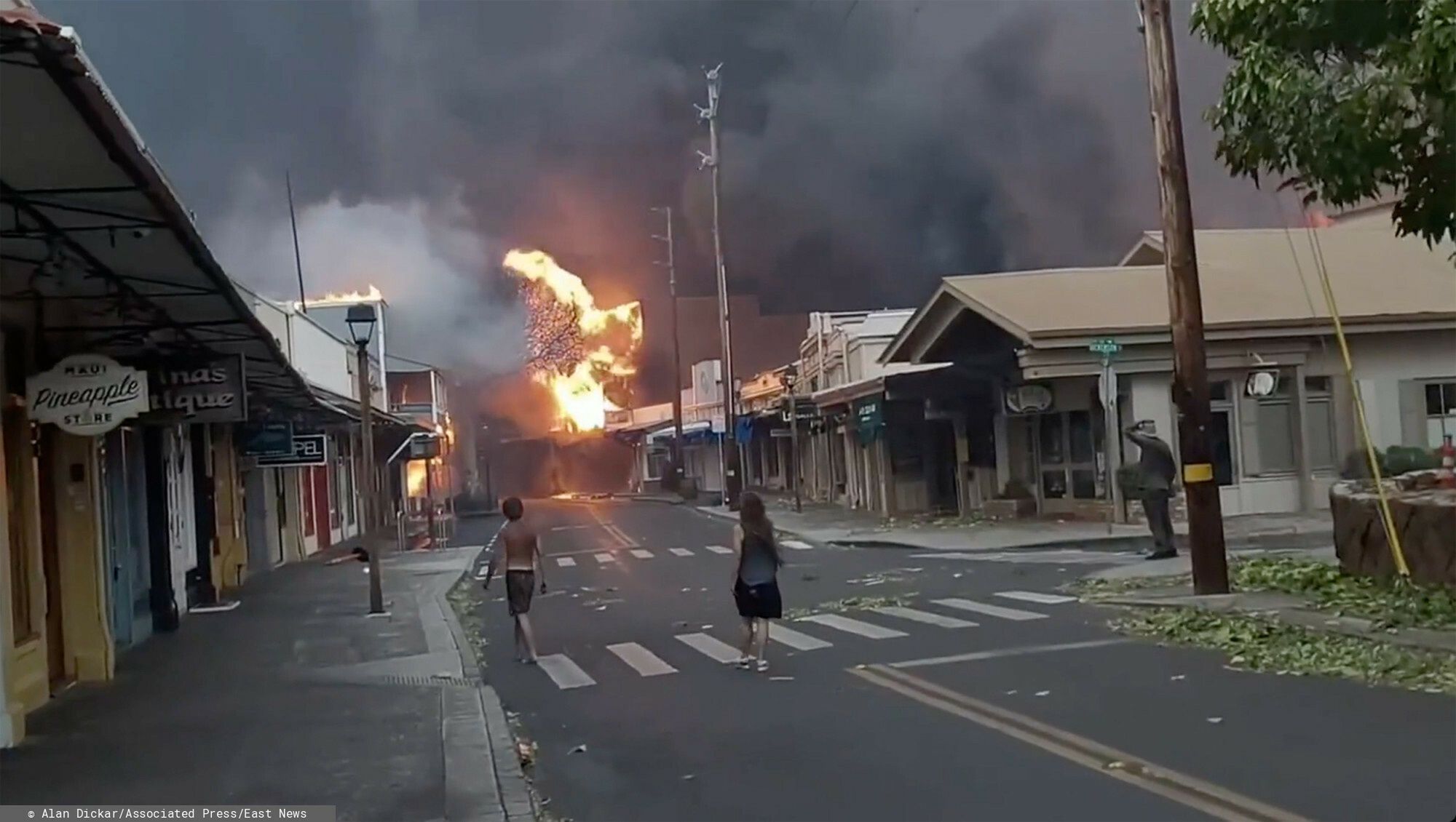 Temporary
People watch as smoke and flames fill the air from raging wildfires on Front Street in downtown Lahaina, Maui on Tuesday, Aug. 9, 2023. Maui officials say wildfire in the historic town has burned parts of one of the most popular tourist areas in Hawaii. County of Maui spokesperson Mahina Martin said in a phone interview early Wednesday says fire was widespread in Lahaina, including Front Street, an area of the town popular with tourists.  (Alan Dickar via AP)
Alan Dickar