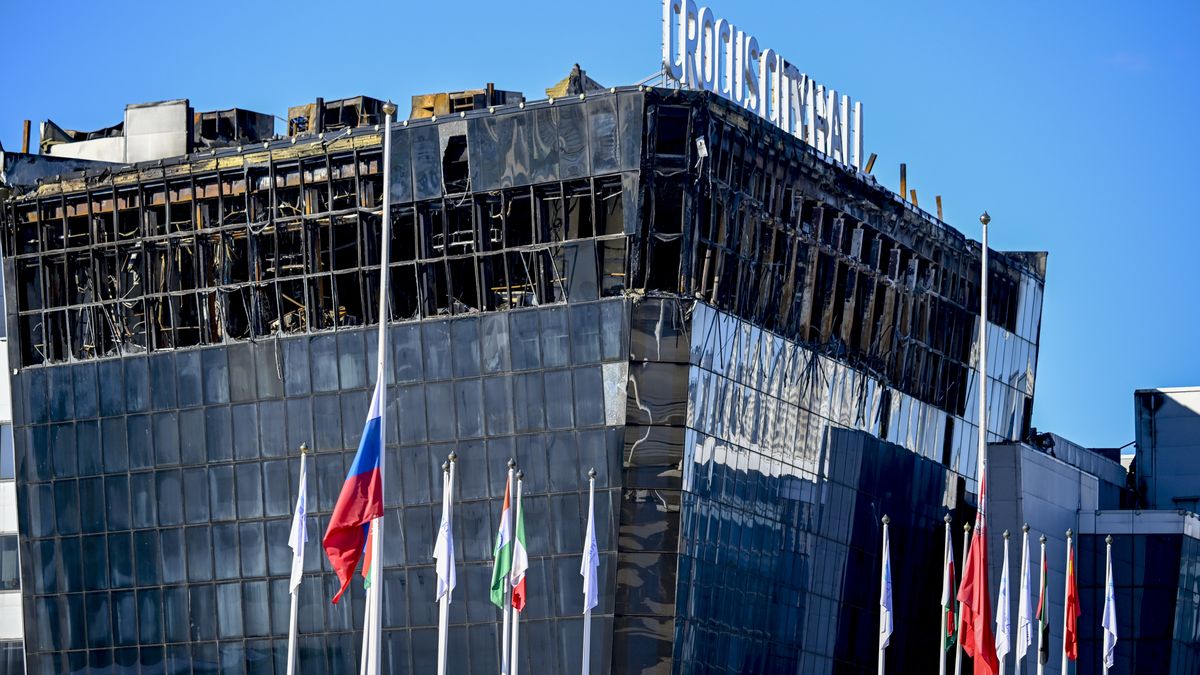 MOSCOW, RUSSIA - MARCH 27: People lay flowers in front of the Crocus City Hall in memory of the victims of the terrorist attack at Crocus Concert Hall in Moscow, Russia on March 27, 2024. The number of fatalities and injuries in last week's concert hall attack in Russia's Moscow region rose to 140 and 360, respectively, local authorities said. The Investigative Committee said it detained 11 people, including four perpetrators, in the border region of Bryansk, who were on their way to Ukraine. (Photo by Sefa Karacan/Anadolu via Getty Images)