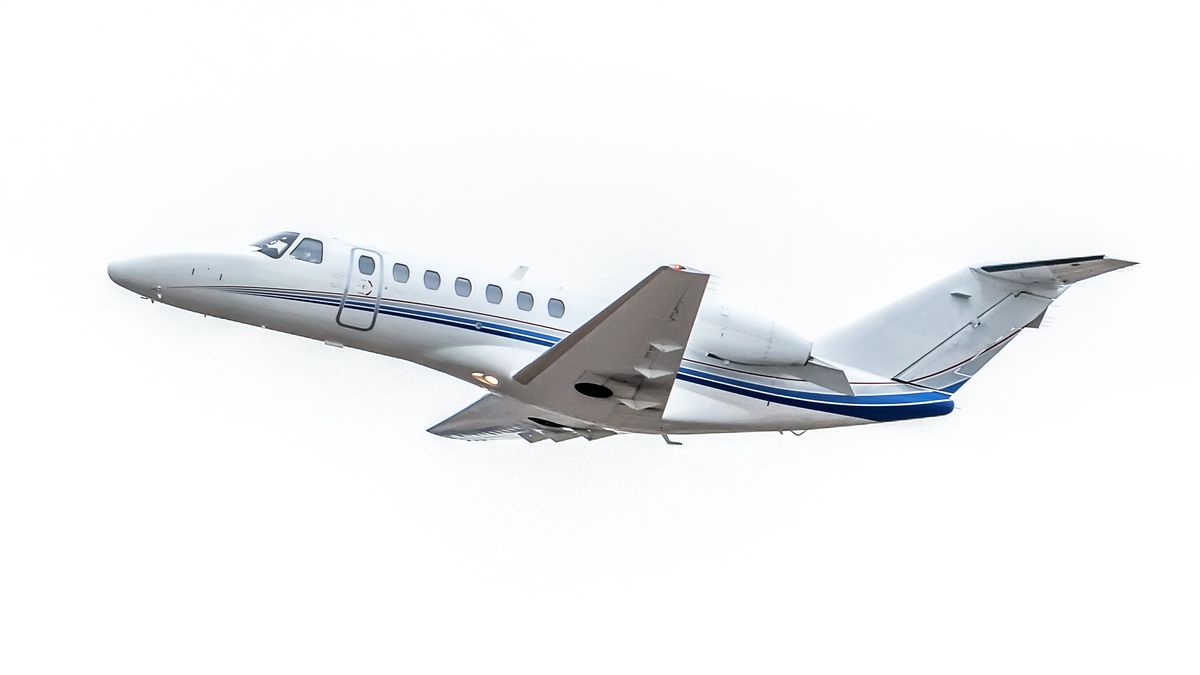 White Sky Private JetSmall private jet just after takeoff - white and blue aircraft against a white sky.Sky Noir Photography by Bill Dic