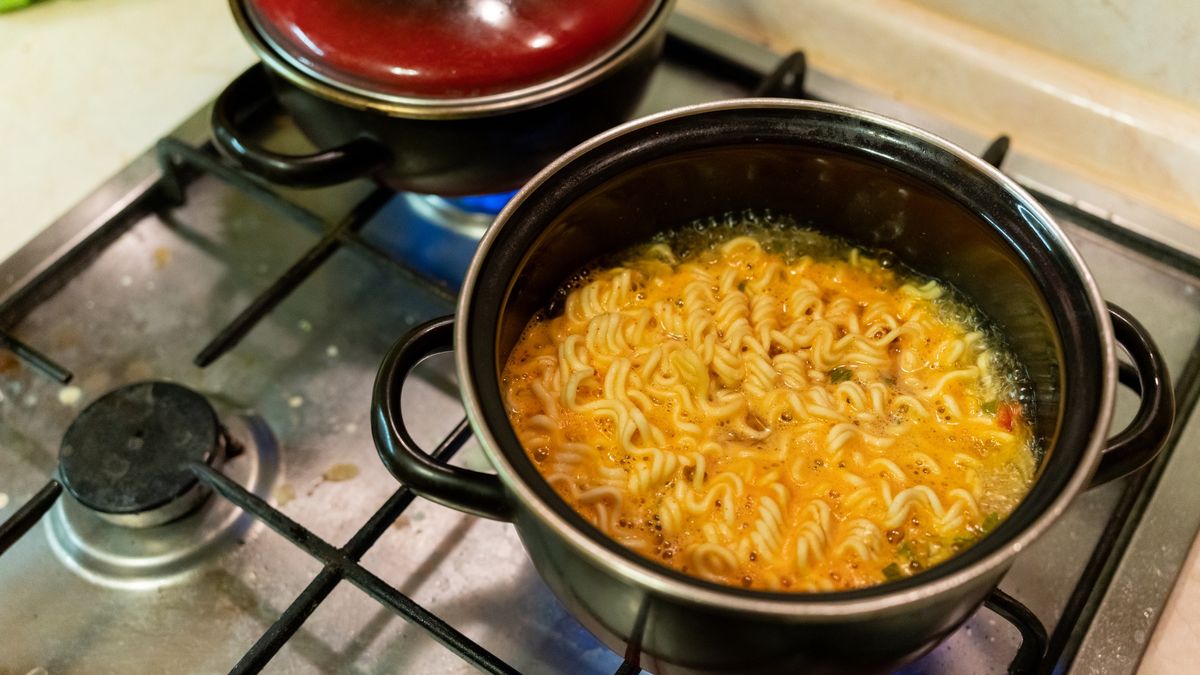 instant noodles in a saucepan are cooked on a gas stove close-upinstant noodles in a saucepan are cooked on a gas stove close-upAndrei Marchenko