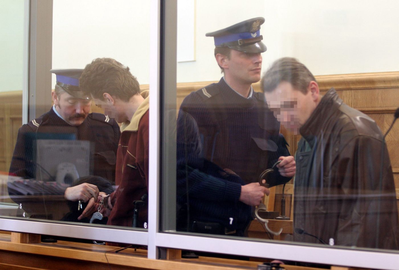 Łódź, 04.04.05. Dwaj byli sanitariusze, 36-letni Andrzej N. (2L) i 38-letni Karol B. (2P) w sali Sądu Okręgowego w Łodzi