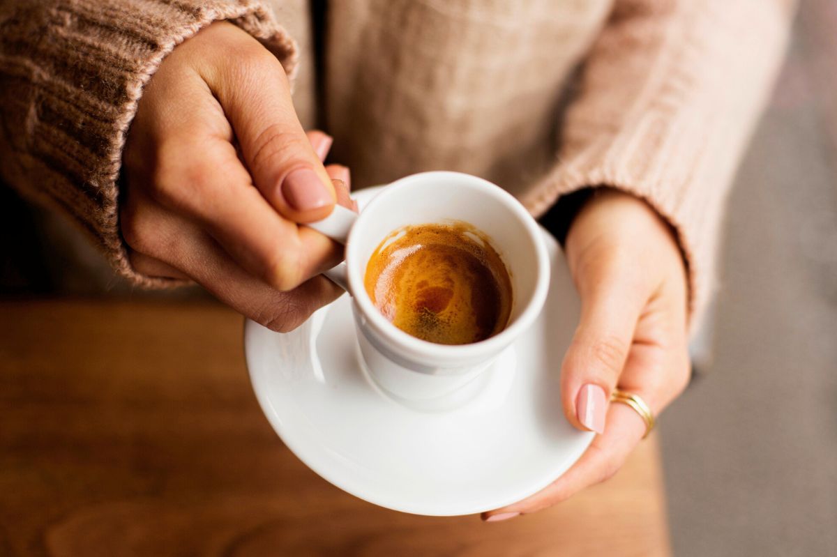 Woman with an espresso cup in hand