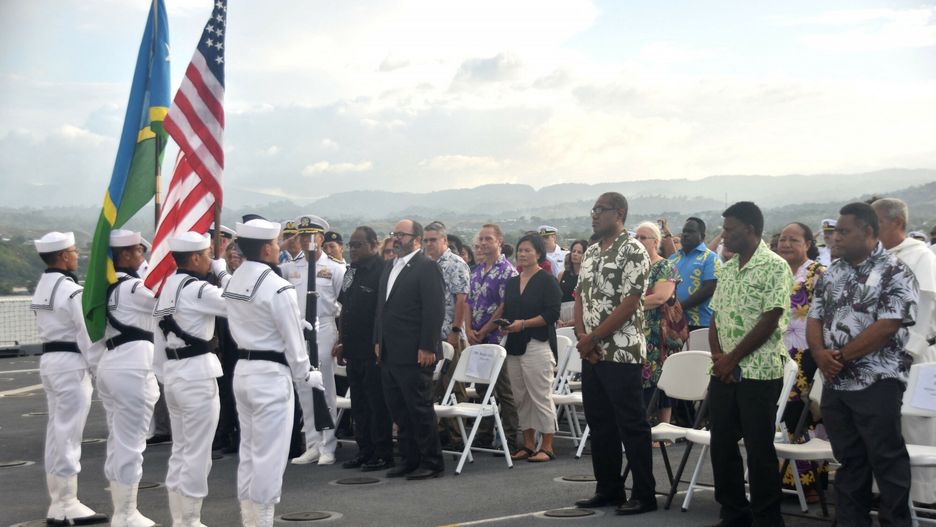 Wojskowi i cywile, reprezentujący Australię, USA, Wyspy Salomona podczas ceremonii upamiętniającej partnerstwo na Pacyfiku. Wydarzenie odbywało się  w sierpniu tego roku na pokładzie USNS Mercy 