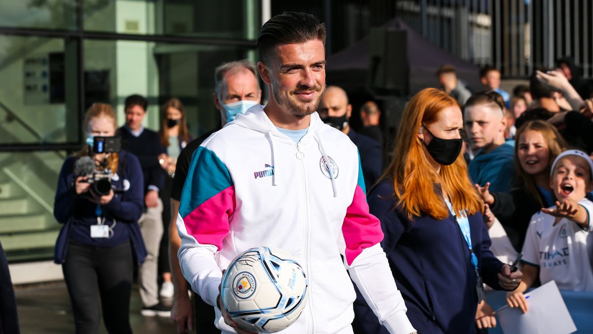 MANCHESTER, ENGLAND - AUGUST 09: Jack Grealish of Manchester City hands out mini club footballs to the crowd during the Jack Grealish Welcome Show at Manchester City Football Academy on August 9, 2021 in Manchester, England. (Photo by Manchester City FC/Manchester City FC via Getty Images)