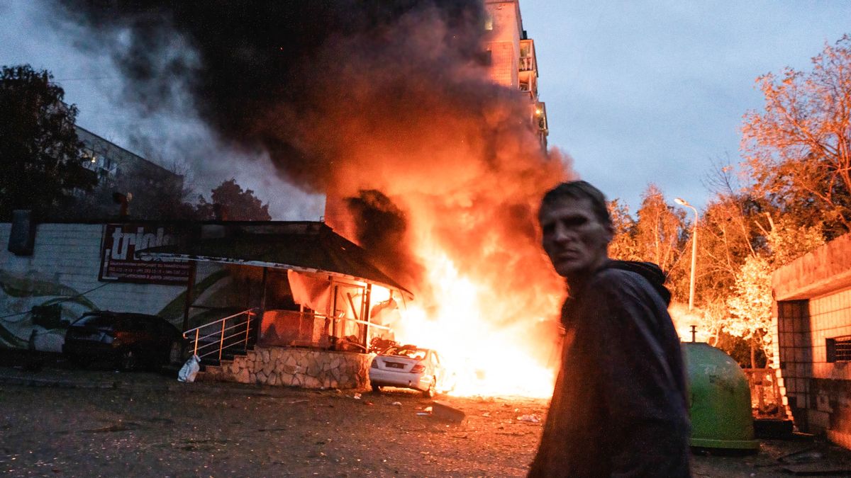 KYIV, UKRAINE - 2025/07/31: A resident walks past a fire following the Russian missile attack. On July 31, 2025, a massive Russian missile and drone attack on Kyiv left at least 16 people dead, including two children, and caused widespread destruction. Ukrainian forces intercepted most of the 309 drones and eight cruise missiles, but some struck residential areas, collapsing a section of a nine-story building. Over 100 buildings were damaged across 27 locations, including schools, hospitals, and homes. (Photo by Patryk Jaracz/SOPA Images/LightRocket via Getty Images)