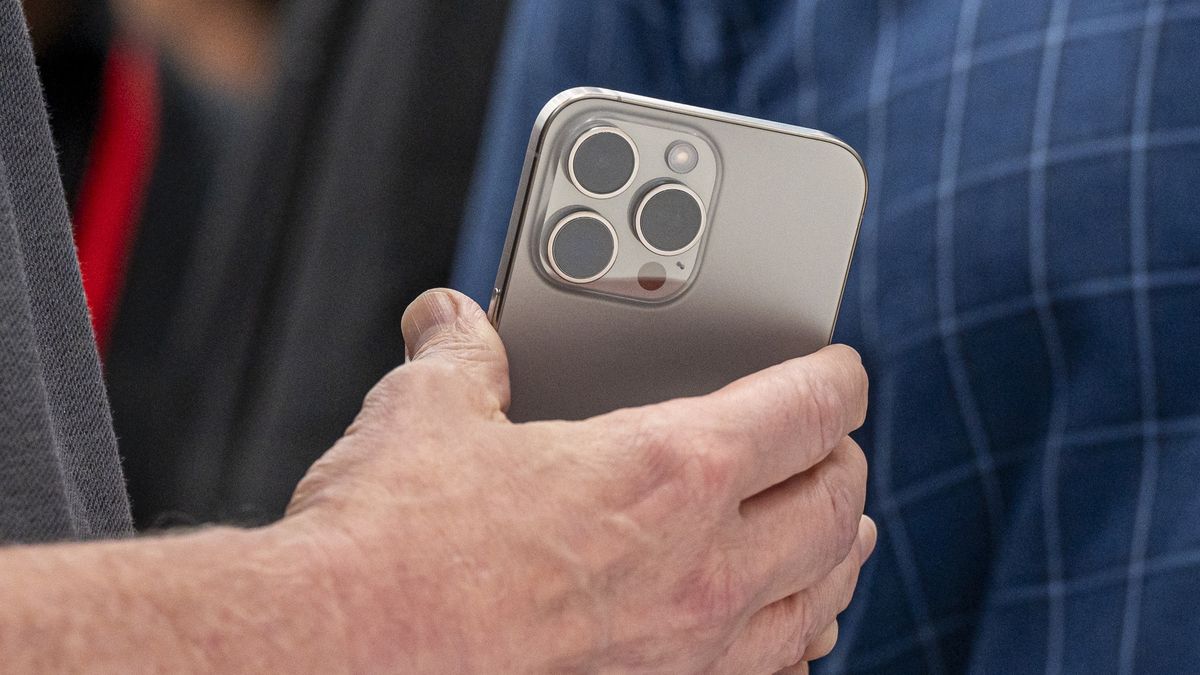 Tim Cook, chief executive officer of Apple Inc., holds an iPhone 15 Pro Max during an event at Apple Park campus in Cupertino, California, US, on Tuesday, Sept. 12, 2023. Apple Inc. introduced its latest iPhones at an event Tuesday, banking on new materials, camera upgrades and improved performance to coax back consumers in a sluggish smartphone market. Photographer: David Paul Morris/Bloomberg via Getty Images