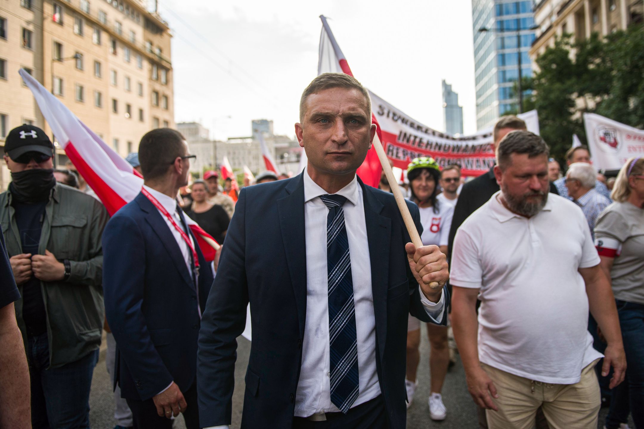 WARSAW, MAZOWIECKIE, POLAND - 2022/08/01: Robert Bakiewicz, leader of the Independence March Association, walks with a Polish flag during the march in Warsaw. Thousands of people participated in a march organized by nationalist organizations to celebrate the 75th anniversary of the Warsaw Uprising. The Warsaw Uprising (Powstanie Warszawskie) was the largest military operation by any European resistance movement against the Nazi German occupiers during World War II. (Photo by Attila Husejnow/SOPA Images/LightRocket via Getty Images)