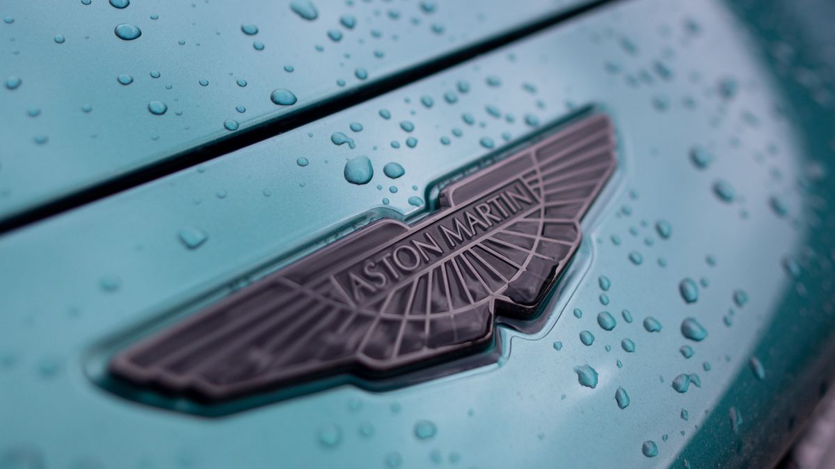 The front badge on an Aston Martin DBX sport utility vehicle (SUV) at the Aston Martin Lagonda Global Holdings Plc factory in St Athan, UK, on Thursday, March 23, 2023. Aston surged after the loss-making manufacturer said itll boost deliveries of lucrative models like the £190,000 ($229,349) DBX707 sport utility vehicle. Photographer: Chris Ratcliffe/Bloomberg via Getty Images