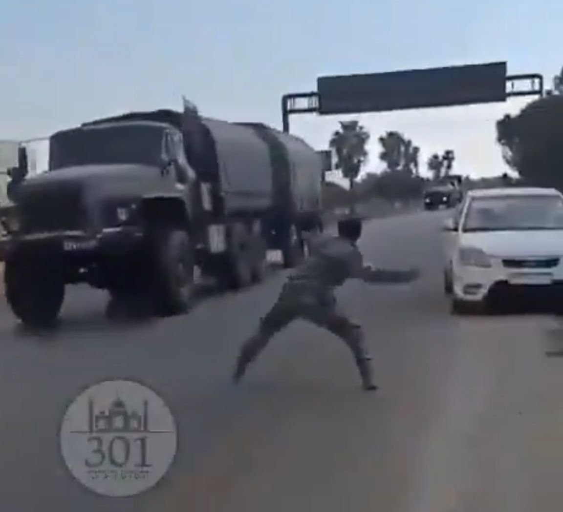 One of the Syrians throwing stones at Russian trucks.