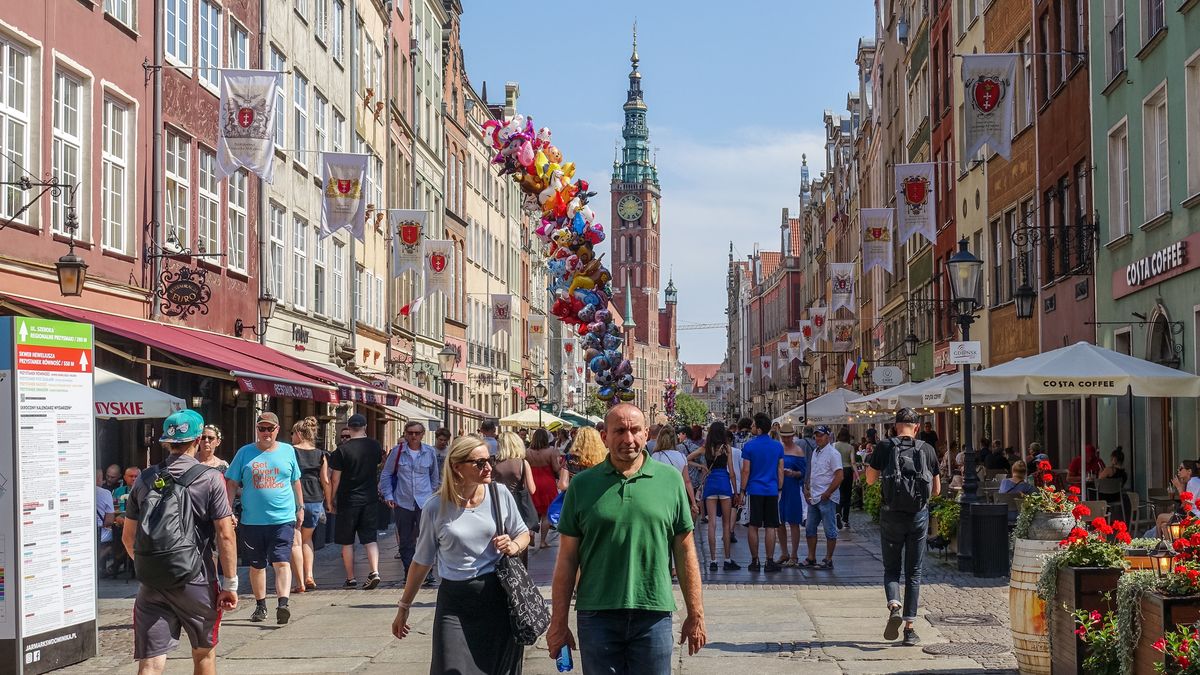 Genereal view of the Dluga street with thousands of tourists visiting the city is seen. People looking for for goods on on stalls and stands on the Old Town streets are seen in Gdansk, Poland, on 14 August 2022 Traders, artists and collectors participate in the Fair occupying with their stands several streets in the centre of the in the historical city centre. St. Dominics Fair is the largest open-air trade and cultural event in Poland and one of the largest such events in Europe.  (Photo by Michal Fludra/NurPhoto via Getty Images)