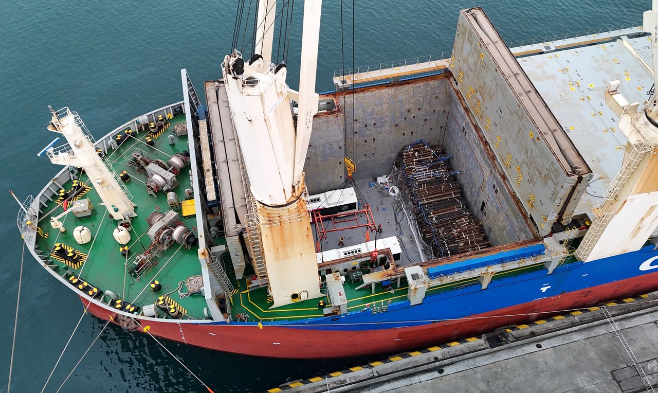 QINGDAO, CHINA - MARCH 07: A new energy bus is hoisted before loading onto a ship at Qingdao Port on March 7, 2024 in Qingdao, Shandong Province of China. The first batch of 53 new energy buses made by Chinese bus manufacturers were shipped from the Qingdao Port in Shandong Province, heading to European countries. (Photo by Zhang Jingang/VCG via Getty Images)