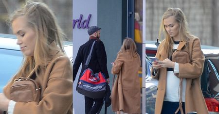 Ciężarna Agnieszka Kaczorowska z nosem w telefonie odprowadza męża na trening (ZDJĘCIA)
