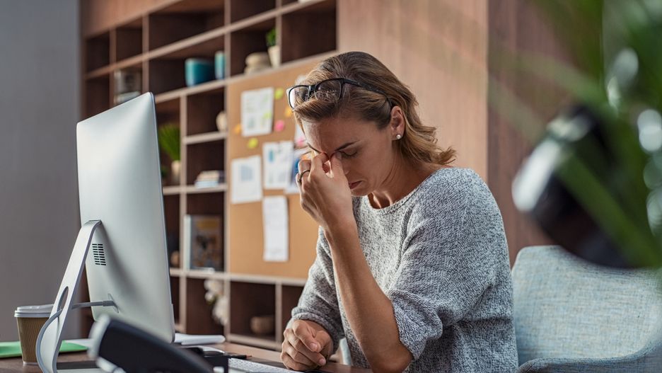 Exhausted businesswoman having a headache in modern office. Mature creative woman working at office desk with spectacles on head feeling tired. Stressed casual business woman feeling eye pain while overworking on desktop computer.headache, business, tired, overworked, woman, stress, late, entrepreneur, exhaustion, computer, businesswoman, worker, work, working, overwork, sitting, office, desk, mature, casual, creative, depression, problem, stressed, people, occupation, stressful, frustration, executive, unhappy, fatigue, desperate, deadline, unsuccessful, night, screen, sight, closed, eyes, burnout, burn out