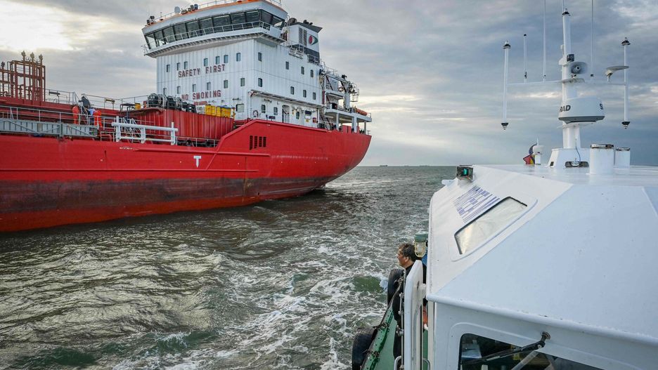 arch51Romanian navigation personnel on a pilot vessel oversees a ship previously anchored on the Black Sea now preparing to enter the Sulina canal, one of the spilling points of the river Danube to the Black Sea in Sulina, south-eastern Romania, on June 8, 2022. - In the Ukrainian port of Izmail, on the Danube river that marks the border with Romania, rows of trucks stand in line, filled with grain. Dozens of kilometres (miles) from there, at Romania's port of Sulina, where the river flows into the Black Sea, ships are seen waiting to be loaded. Sailors say there have never been so many ships of all kinds and under so many flags dotting the horizon at Sulina. They are waiting to reach Ukraine to be loaded with food -- ever since Moscow's blockade of its neighbour's seaports has paralysed grain exports from one of the world's largest producers. (Photo by Daniel MIHAILESCU / AFP)DANIEL MIHAILESCU