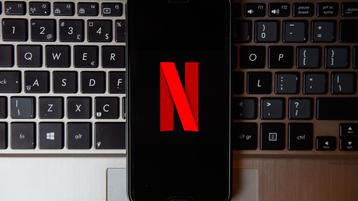 POLAND - 2020/10/21: In this photo illustration a Netflix logo seen displayed on a smartphone with a laptop keyboard on the background. (Photo Illustration by Omar Marques/SOPA Images/LightRocket via Getty Images)