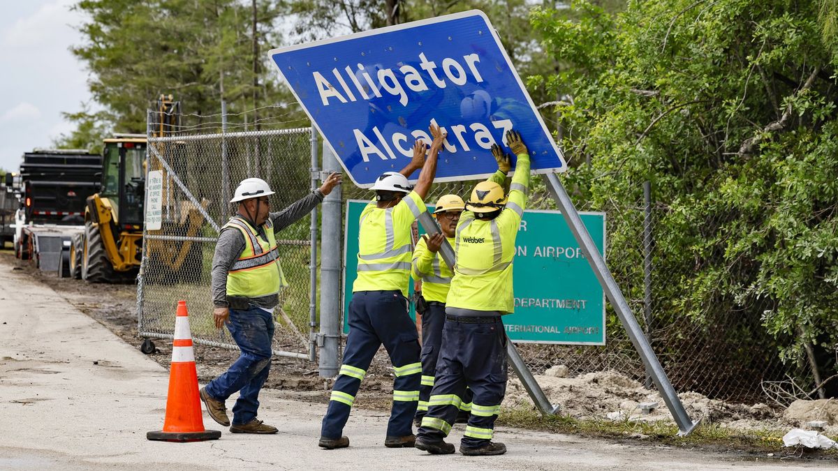 Workers install a permanent Alligator Alcatraz sign, in Collier County, Florida, on Thursday, July 3, 2025. (Al Diaz/Miami Herald/Tribune News Service via Getty Images)
