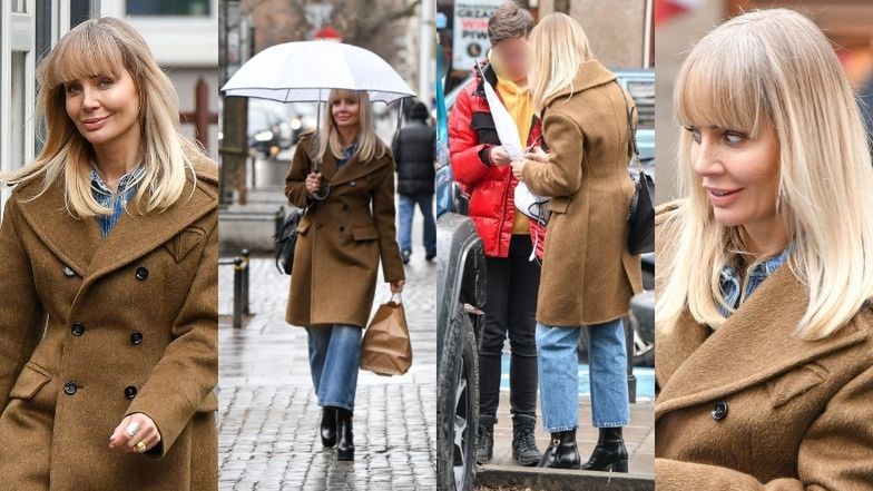 Zaopatrzona w parasol Agnieszka Woźniak-Starak rozdaje autografy na ulicy (ZDJĘCIA)