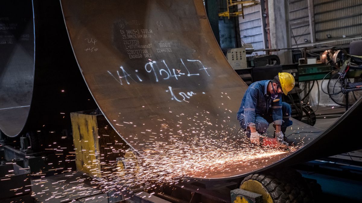 Sparks fly as a worker labors at a bending and welding workshop for wind turbine towers at a CS Wind Corp. factory in Tan Thanh, Ba Ria-Vung Tau Province, Vietnam, on Wednesday, Feb. 15, 2023. Renewables will dominate the growth of the worlds electricity supply over the next three years, according to the International Energy Agency, as countries race to get to zero emissions. Photographer: Linh Pham/Bloomberg via Getty Images