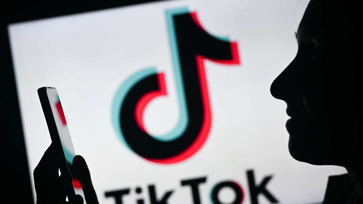 EDMONTON, CANADA - APRIL 28:
An image of a woman holding a cell phone in front of the Tik Tok logo displayed on a computer screen, on April 29, 2024, in Edmonton, Canada. (Photo by Artur Widak/NurPhoto via Getty Images)