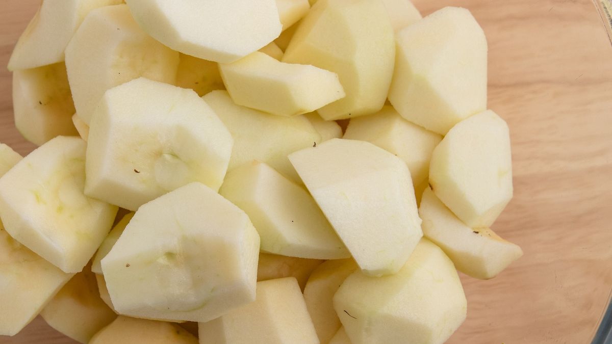 Bowl of chopped applesPeeled, cored and chopped Rennet apples. Glass kitchen bowl on Lazy Susan. High point of view.annick vanderschelden photographapplesauce