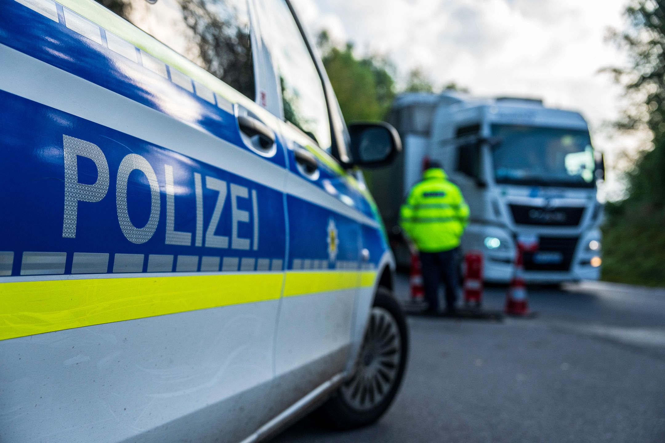 A police officer monitors vehicles crossing the Czech Republic-Germany border in Ulrichsberg, Germany, on Tuesday, Sept. 17, 2024. A temporary extension of border controls to all of Germany's nine land frontiers took effect on Monday, part of an enhanced effort to tackle irregular migration and people smuggling that has irritated some of its neighbors. Photographer: Milan Jaros/Bloomberg via Getty Images