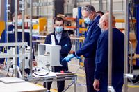 Engineers talk in front of a flow meter on the ventilator production line in an adapted hangar at the Airbus SE assembly plant in Broughton, U.K., on Thursday, April 30, 2020. Industrial giants like Airbus, Siemens AG and Ford Motor Co. will lend factory floors and supply chain heft to meet government orders for 5,000 ventilator machines of the Smiths Group Plc design, which is already approved by medical authorities, and 15,000 Penlon Ltd. devices. Photographer: Paul Thomas/Bloomberg via Getty Images