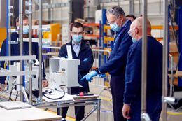 Engineers talk in front of a flow meter on the ventilator production line in an adapted hangar at the Airbus SE assembly plant in Broughton, U.K., on Thursday, April 30, 2020. Industrial giants like Airbus, Siemens AG and Ford Motor Co. will lend factory floors and supply chain heft to meet government orders for 5,000 ventilator machines of the Smiths Group Plc design, which is already approved by medical authorities, and 15,000 Penlon Ltd. devices. Photographer: Paul Thomas/Bloomberg via Getty Images