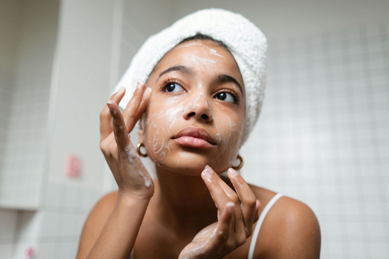 A woman washing her face.