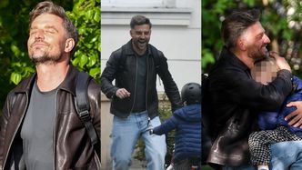 Marcin Rogacewicz ekscytuje się umiejętnościami jazdy na rowerze syna i tuli go na ławce w parku (ZDJĘCIA)