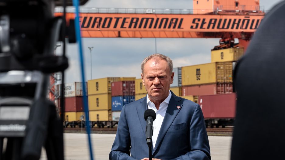 Prime Minister of Poland, Donald Tuskspeaks to press in Euroterminal Slawkow that provides train transport with Ukraine and Asia in Slawkow, Silesian voivodeship, Poland on May 26, 2025. Train transport with the East of Europe, including Ukraine and with Asia pose difficulties as Eastern countries have different width of train tracks. Euroterminal Slawkow is one of a few logistic hubs that can provide load transport onto Eastern size tracks. Poland aims to invest in the hub. (Photo by Dominika Zarzycka/NurPhoto via Getty Images)