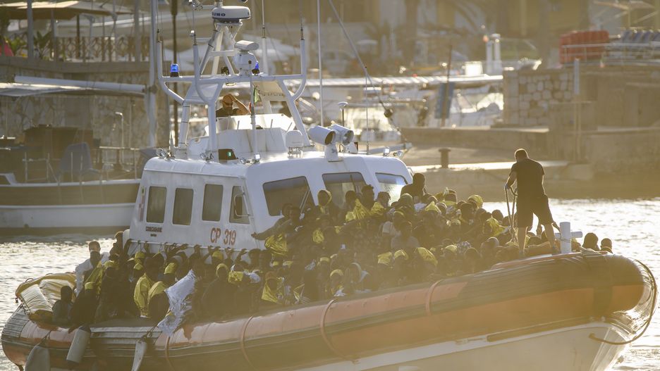 LAMPEDUSA ISLAND, ITALY - SEPTEMBER 16: A patrol boat of the Italian Coastguard arrives at molo Favaloro with migrants, on September 16, 2023 in Lampedusa, Italy. The small Sicilian island of Lampedusa is overwhelmed with nearly 7000 migrants arrived in the last 48 hours. The majority of migrants, mainly of African origins, departed from Tunisia. People working in the humanitarian assistance are facing increasing difficulties in transferring and hosting people in the hotspot, which could normally host 400 migrants. Local and regional authorities asked help from the Italian Government to deal with the emergency situation. (Photo by Valeria Ferraro/Anadolu Agency via Getty Images)