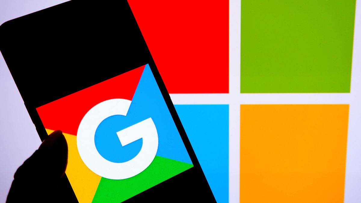 INDIA - 2023/02/12: In this photo illustration, a Google logo is seen displayed on a smartphone with a Microsoft logo in the background. (Photo Illustration by Avishek Das/SOPA Images/LightRocket via Getty Images)
