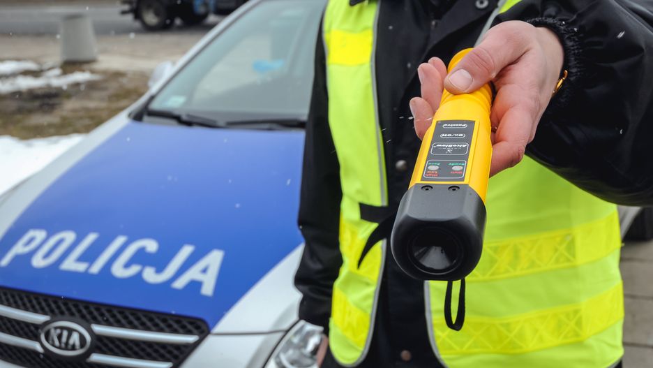 Warsaw, Poland - March 17, 2010: Policeman holds AlcoBlow alcohol meter for fast, preliminary drivers testing during field sobriety testingpoland, polish, warsaw, city, police, police force, car, kia, police car, cruiser, police cruiser, patrol car, prowl car, squad car, sign, policeman, officer, police officer, vest, yellow, traffic control police, traffic, traffic control, road police, traffic police, check, checking, control, controlling, device, equipment, sobriety, checkpoint, Field sobriety testing, test, testing, standardized, tests, FSTs, AlcoBlow, alcohol, meter, driver, drivers, safety, Breathalyzer, Breath, analyzer, Alcometer, fast, preliminary, tester, law, intoxicated, cop, man, trooper, hold, holding, show, showing, poland, polish, warsaw, city, police, police force, car, kia, police car, cruiser, police cruiser, patrol car, prowl car, squad car, sign, policeman, officer, police officer, vest, yellow, traffic control police, traffic, traffic control, road police, traffic police, check, checking, control, controlling, device, equipment, sobriety, checkpoint, field sobriety testing, test, testing, standardized, tests, fsts, alcoblow, alcohol, meter, driver, drivers, safety, breathalyzer, breath, analyzer, alcometer